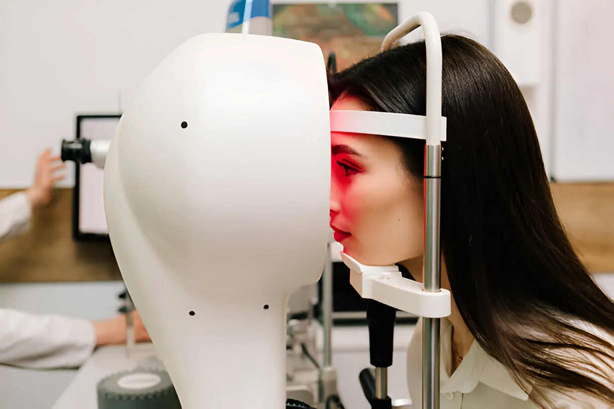 Woman undergoing an eye scan with advanced ophthalmic equipment, illustrating ophthalmology medical billing services.