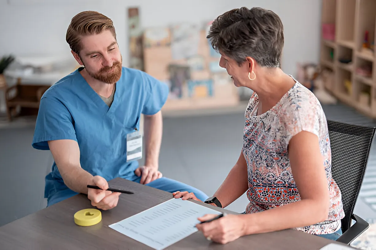 Therapist reviewing documents with a patient during occupational therapy billing services discussion